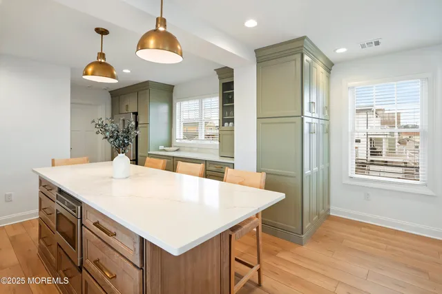 a kitchen with stainless steel appliances granite countertop a sink a stove a refrigerator and cabinets