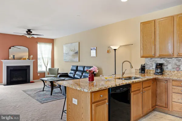a kitchen with stainless steel appliances granite countertop a sink and cabinets