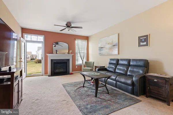 a living room with furniture a fireplace and a table