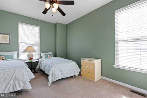 a bedroom with two beds and a window