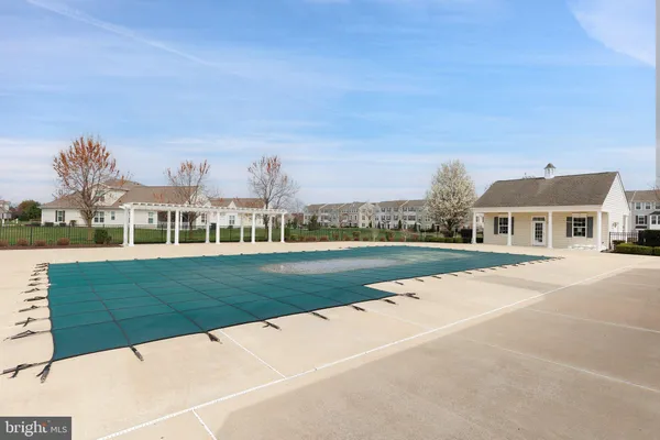 a dining room with a bookshelf and a chandelier