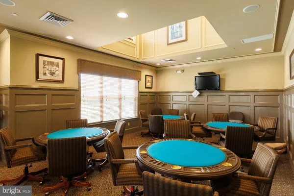 a room with pool table and windows