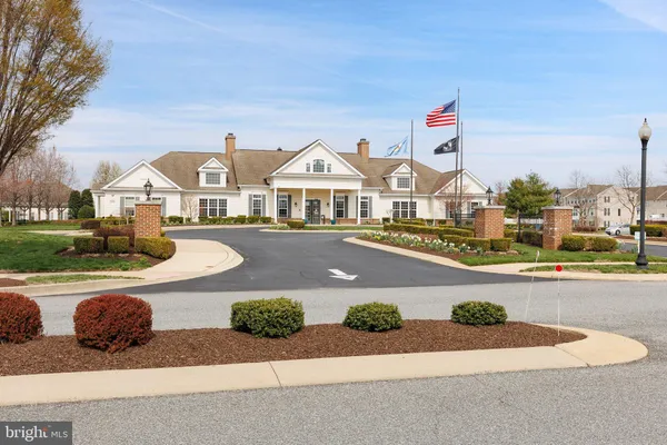 a sign board with a play ground in the back