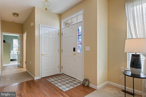 a view of a livingroom with wooden floor and bathroom view