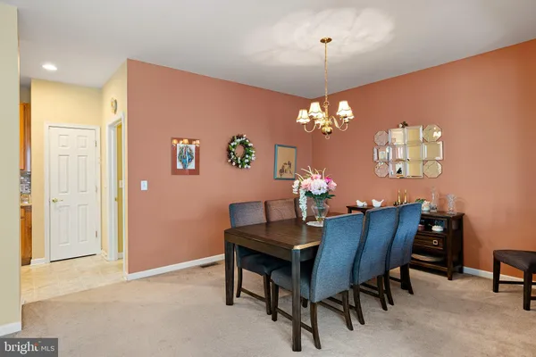 a view of a dining room with furniture and chandelier