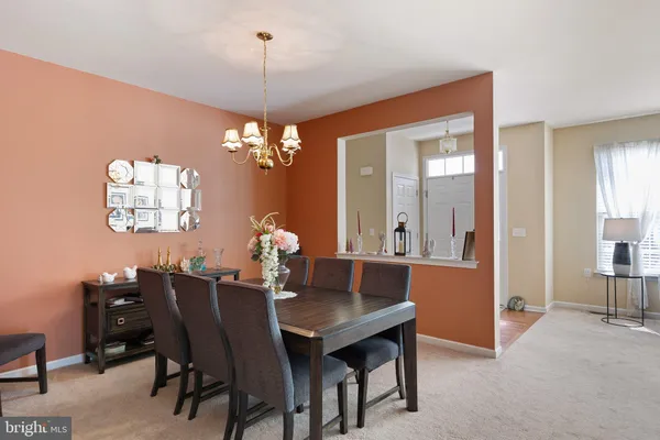 a view of a dining room with furniture and chandelier