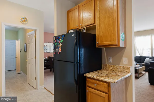 a kitchen with a refrigerator and a stove top oven