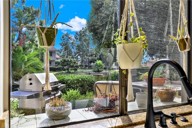 a front view of a house with garden and sitting area