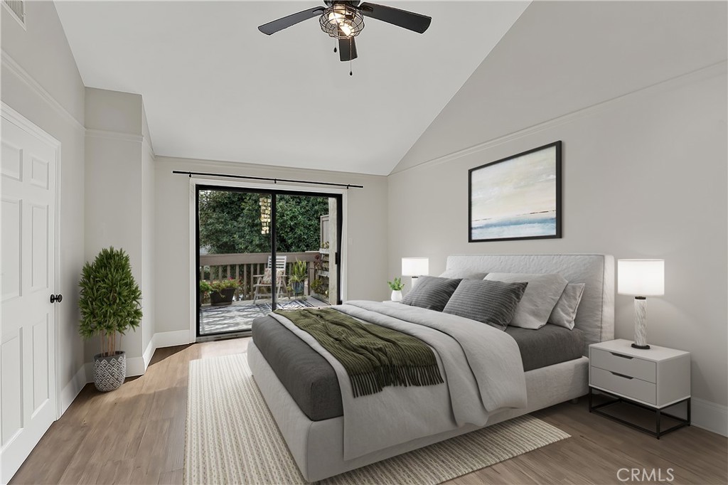 27112 Mill Pond Road, Unit 2 Dana Point, CA 92624 - Photo 21 of 50 a bedroom with a large bed and a chandelier