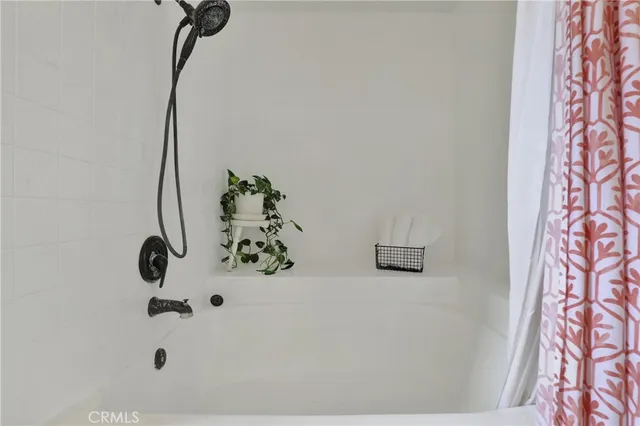 a bathroom with a bathtub and shower
