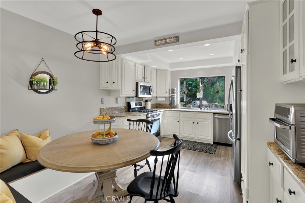 27112 Mill Pond Road, Unit 2 Dana Point, CA 92624 - Photo 9 of 50 a view of a dining room with furniture wooden floor and chandelier