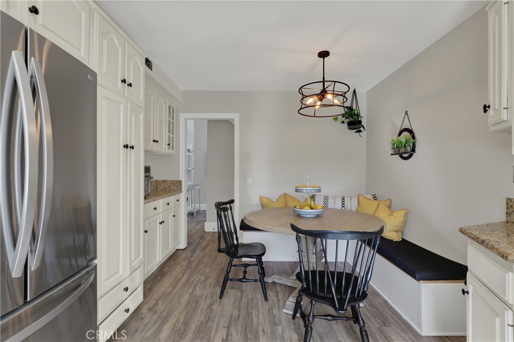 27112 Mill Pond Road, Unit 2 Dana Point, CA 92624 - Photo 10 of 50 a dining room with furniture a chandelier and wooden floor