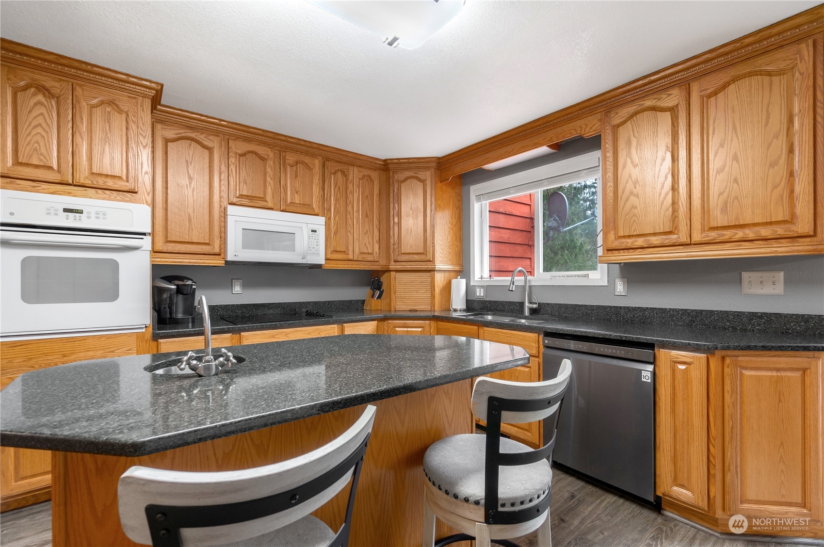 2712 Seminary Hill Road Centralia, WA 98531 - Photo 11 of 40 a kitchen with stainless steel appliances granite countertop a sink a stove a table and chairs