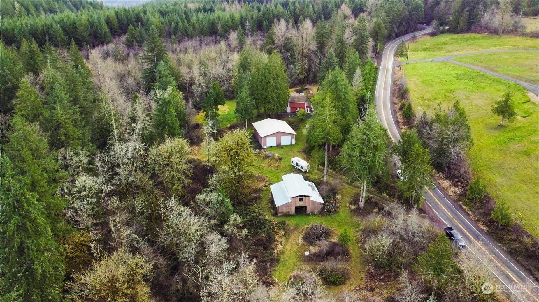 2712 Seminary Hill Road Centralia, WA 98531 - Photo 6 of 40 a backyard of a house with lots of green space and a lake view