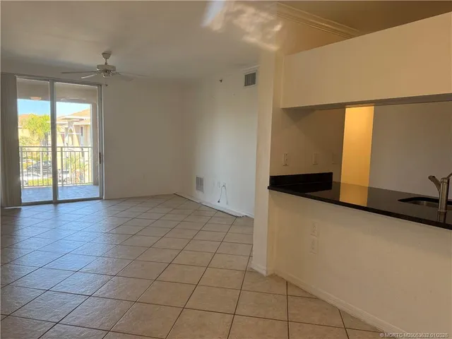 a kitchen with granite countertop a sink and a stove