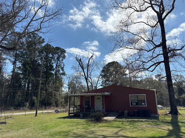 a view of a house with a tree in front of it