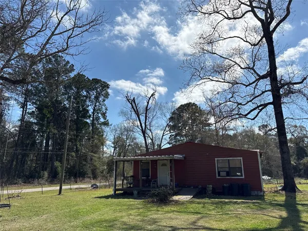 a view of a house with a tree in front of a house