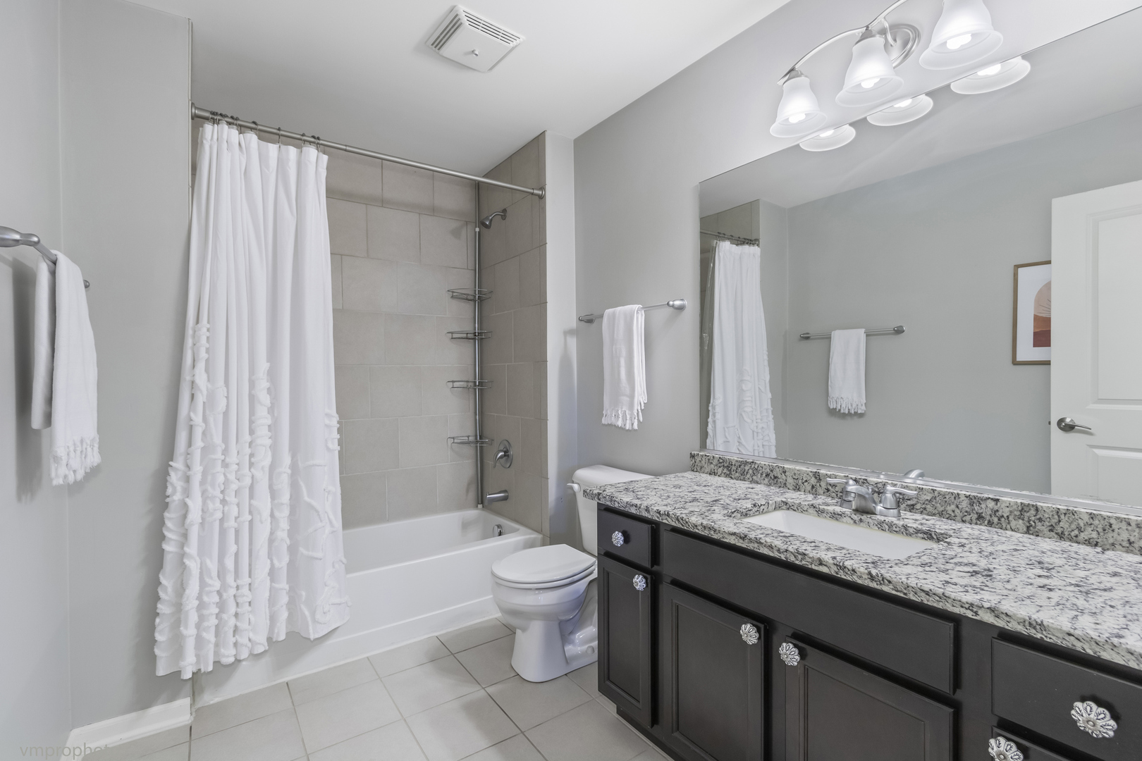 28 East Moseley Road Palatine, IL 60074 - Photo 14 of 25 a bathroom with a granite countertop sink a toilet a mirror a bathtub and shower