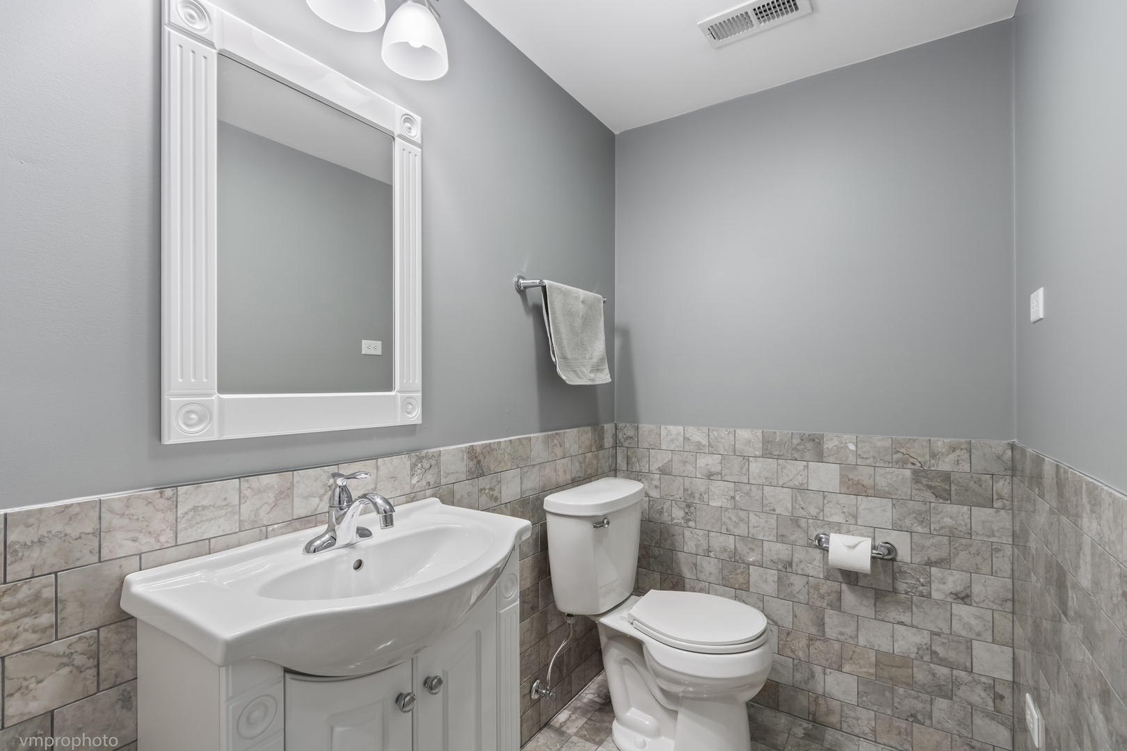 28 East Moseley Road Palatine, IL 60074 - Photo 18 of 25 a bathroom with a sink a toilet and mirror