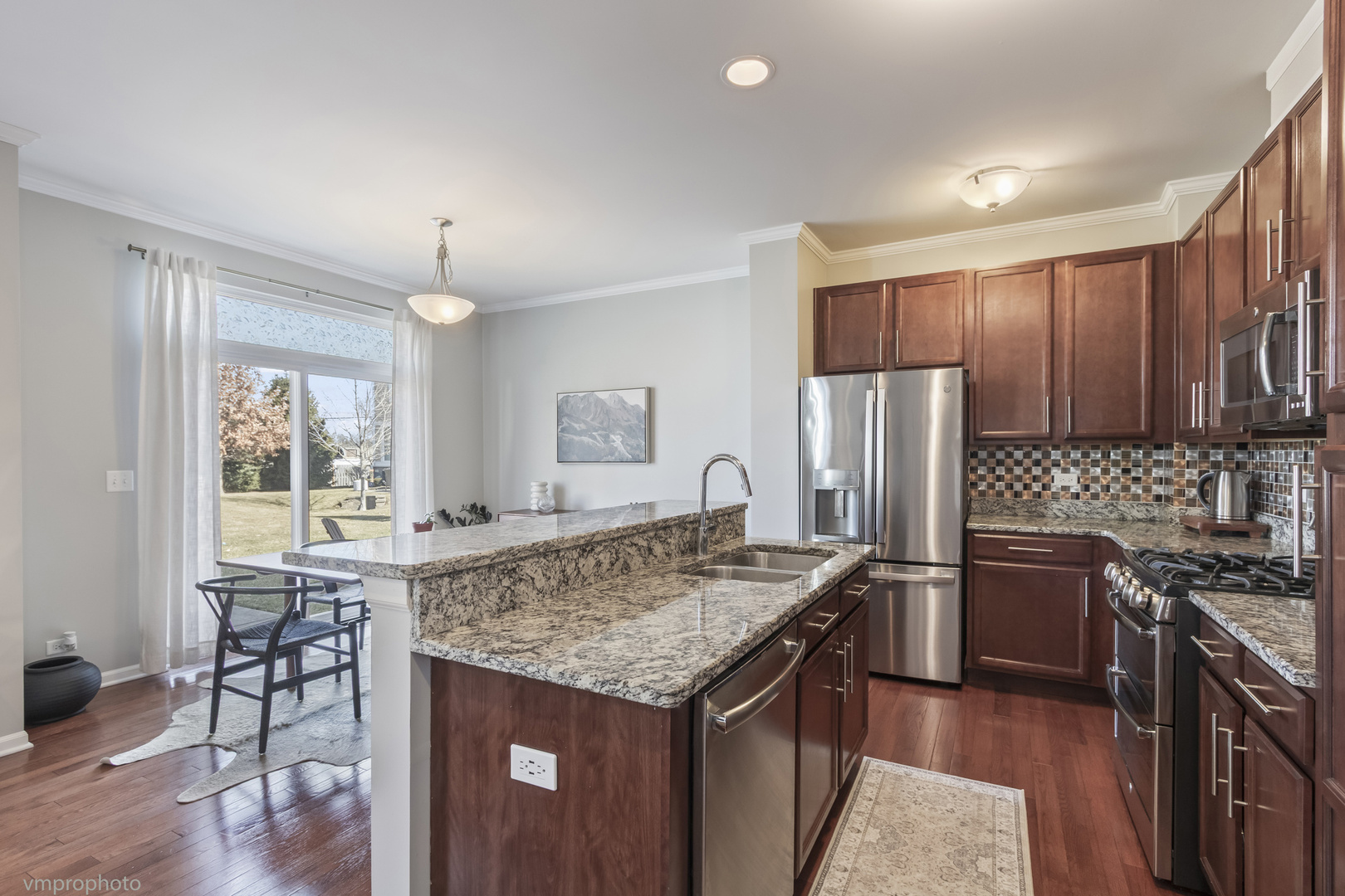 28 East Moseley Road Palatine, IL 60074 - Photo 7 of 25 a kitchen with stainless steel appliances granite countertop a stove refrigerator and a microwave
