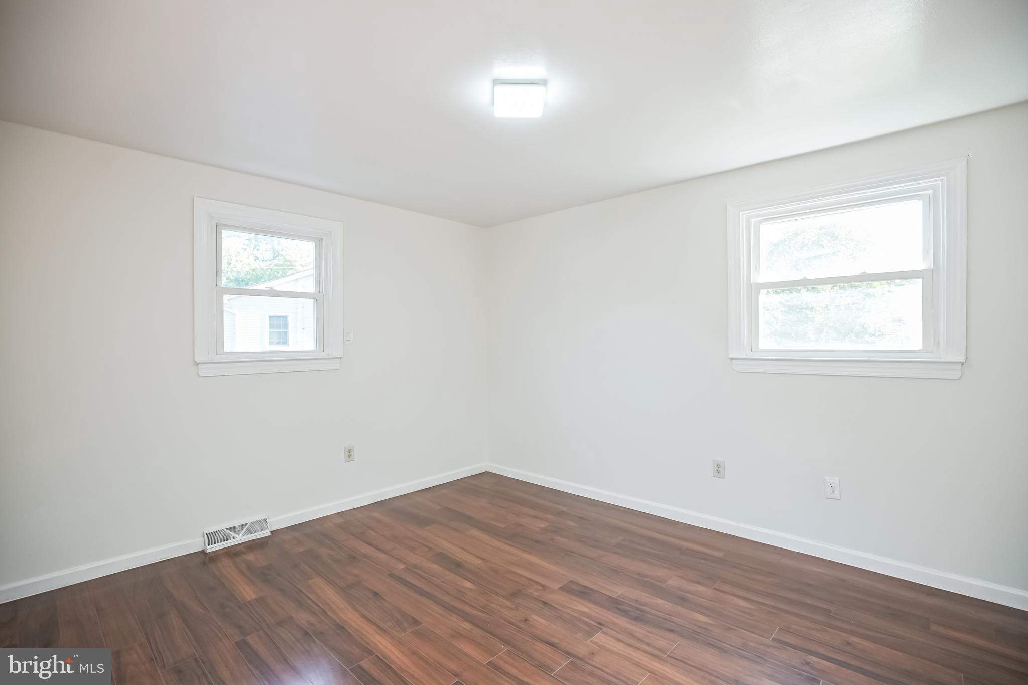 161 New Freedom Road Berlin, NJ 08009 - Photo 12 of 31 an empty room with wooden floor and windows