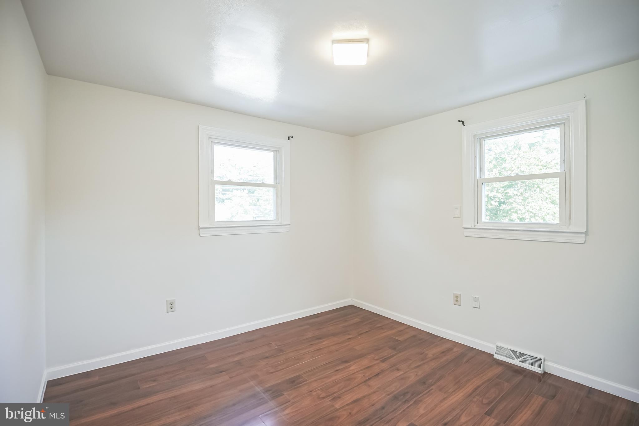161 New Freedom Road Berlin, NJ 08009 - Photo 13 of 31 an empty room with wooden floor and windows