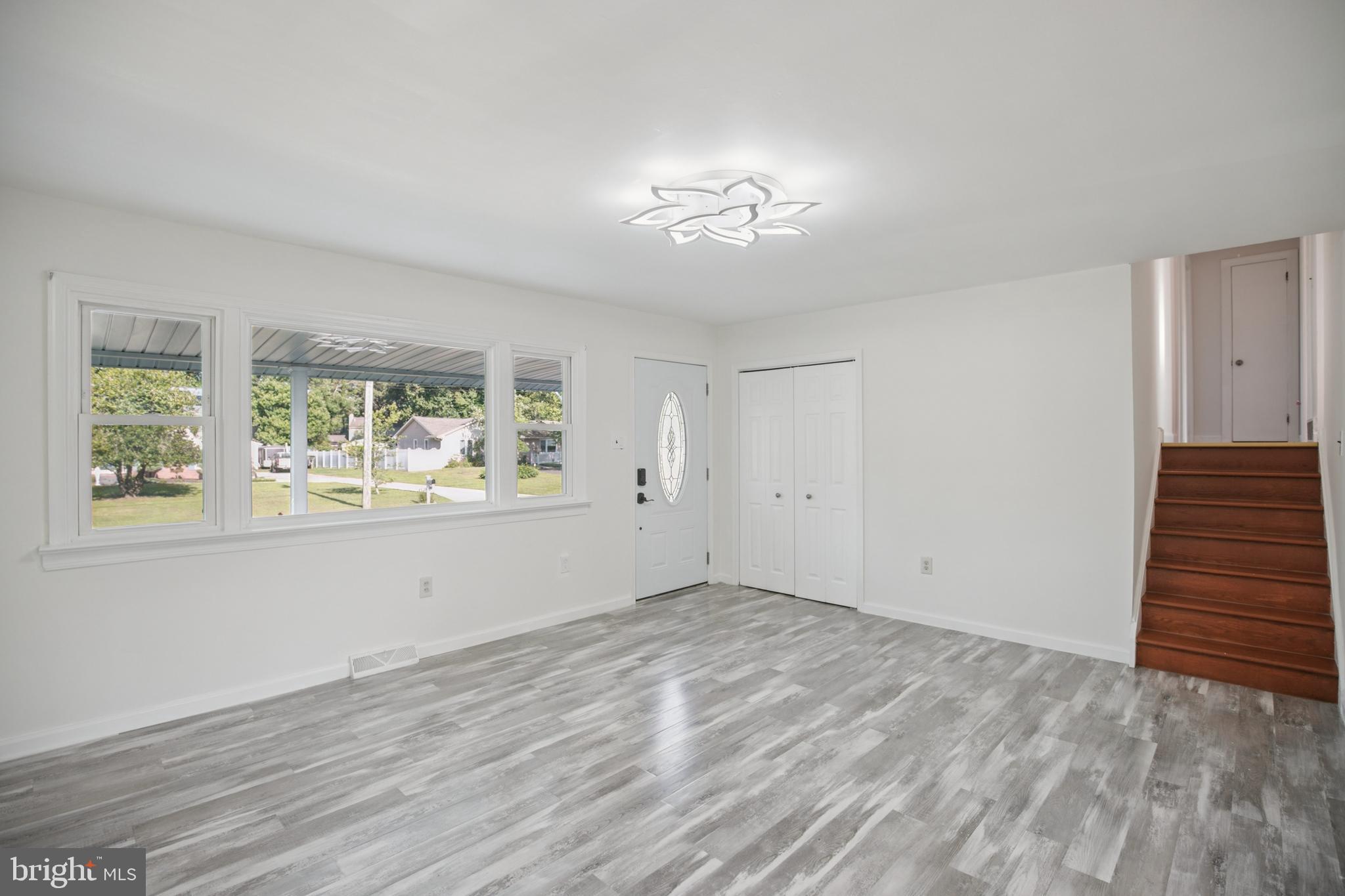 161 New Freedom Road Berlin, NJ 08009 - Photo 4 of 31 a view of an empty room with wooden floor and a window