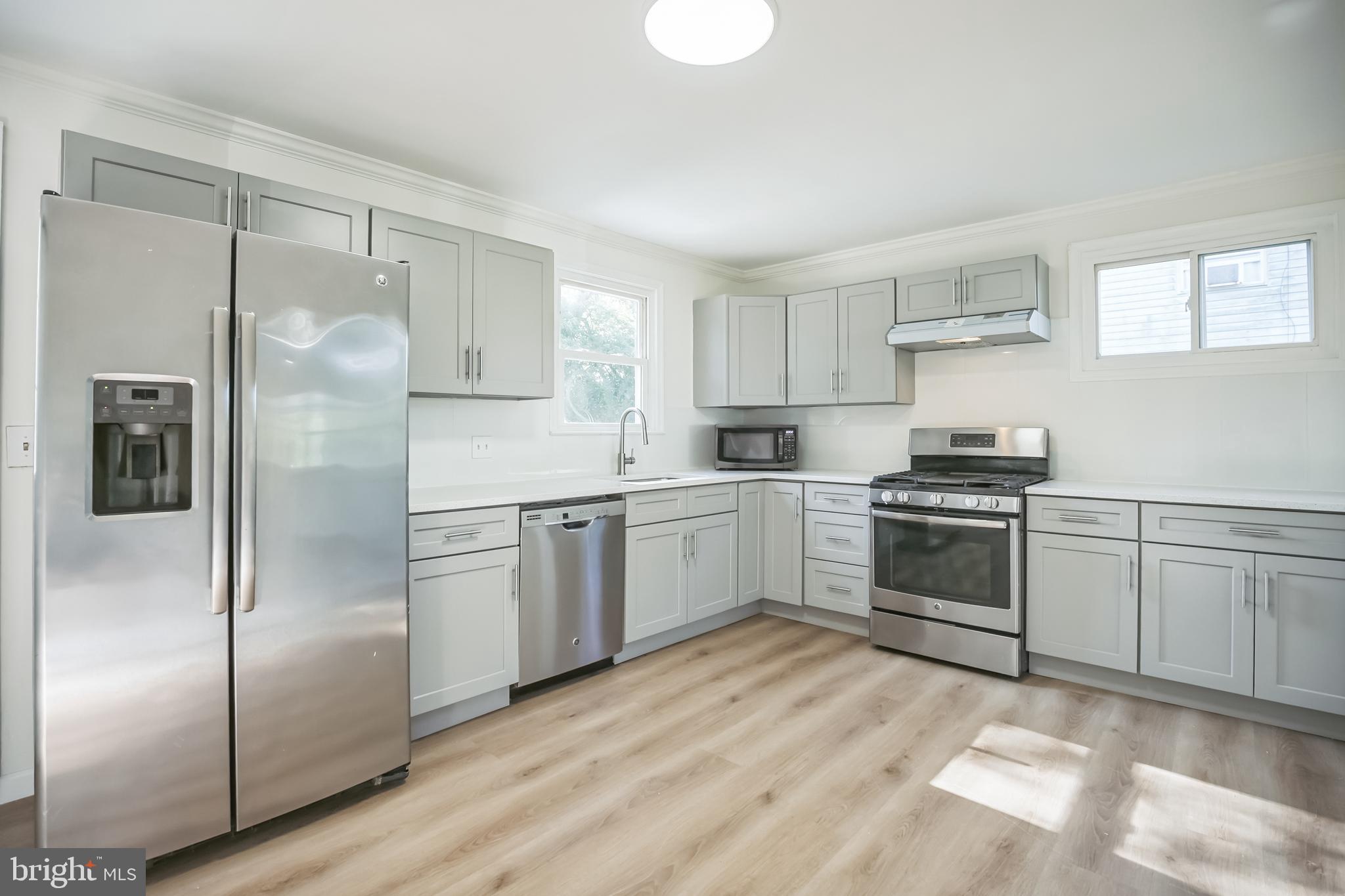 161 New Freedom Road Berlin, NJ 08009 - Photo 7 of 31 a kitchen with a refrigerator and white cabinets