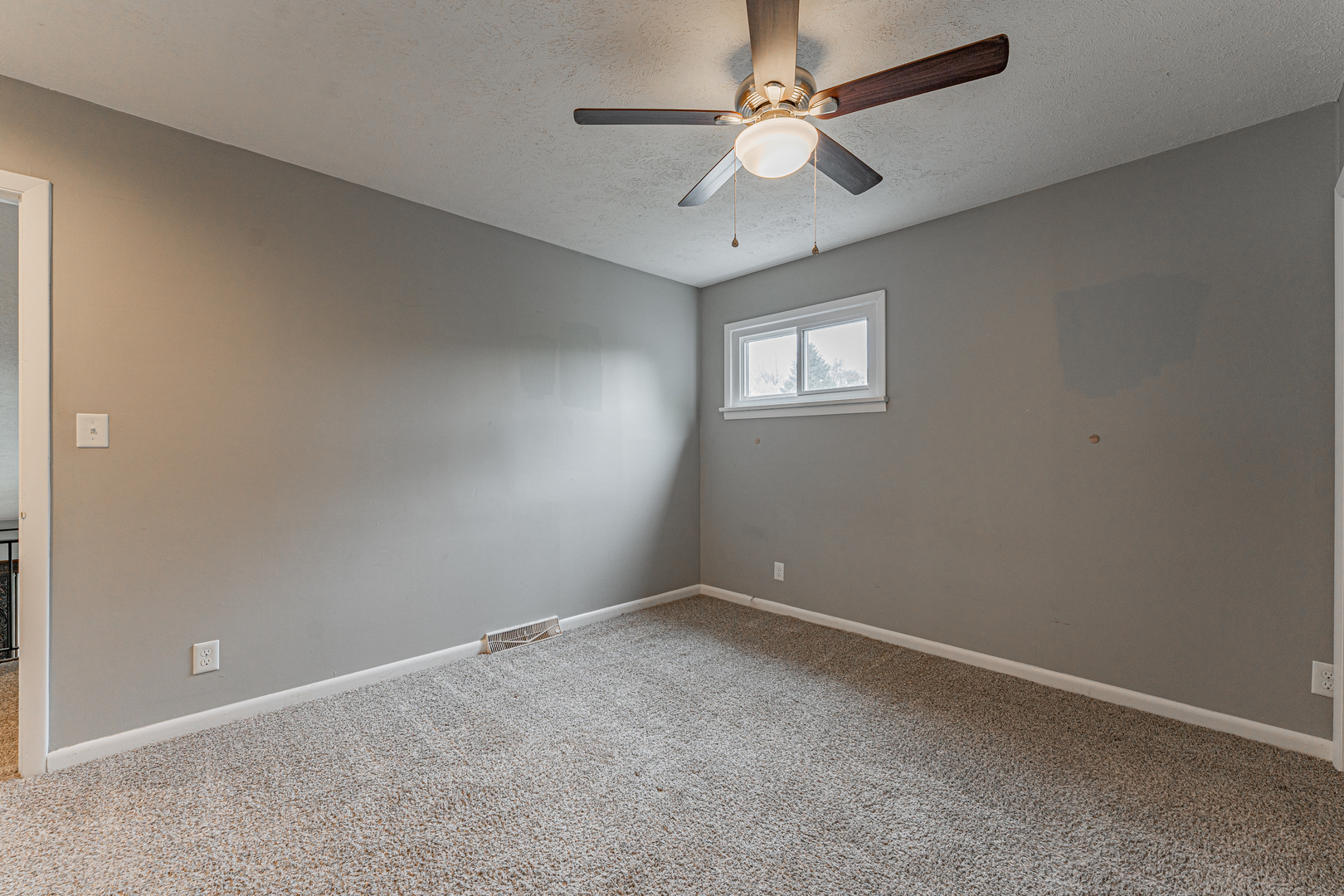 805 South Grove Street Normal, IL 61761 - Photo 21 of 32 an empty room with a chandelier fan and windows
