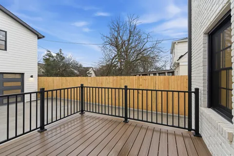 a view of a kitchen with a sink and refrigerator
