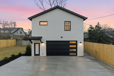 an empty room with wooden floor closet and fan