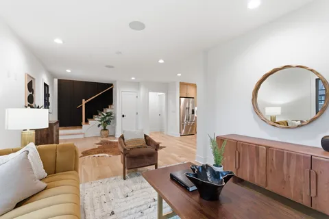a kitchen with cabinets stainless steel appliances and wooden floor