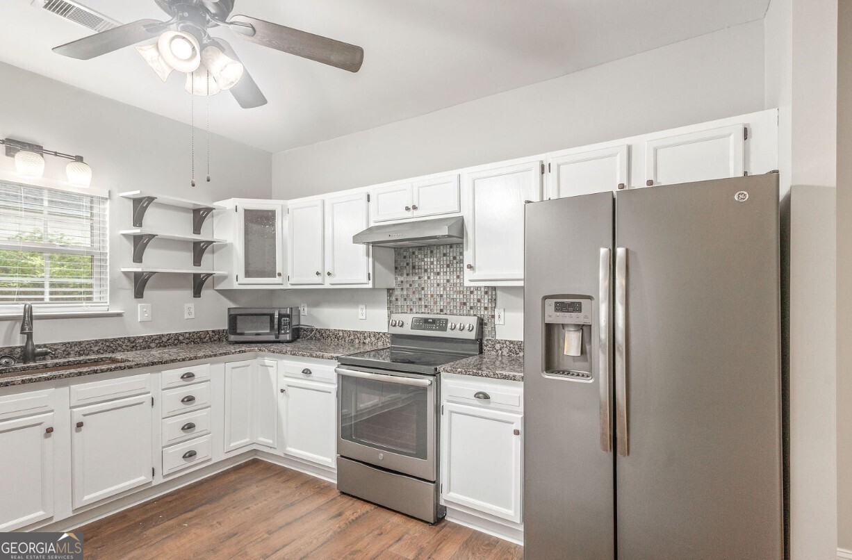 82 Newton Road LaGrange, GA 30240 - Photo 13 of 45 a kitchen with stainless steel appliances a refrigerator sink and cabinets