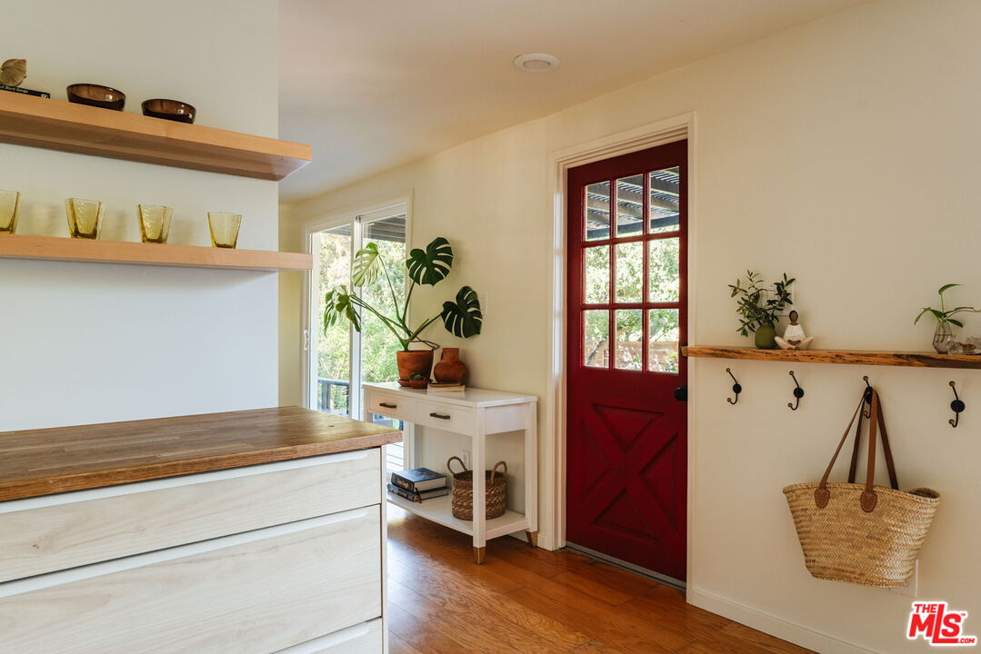20906 Fontaine Road Topanga, CA 90290 - Photo 12 of 73 a living room with stainless steel appliances kitchen island granite countertop furniture and a wooden floor