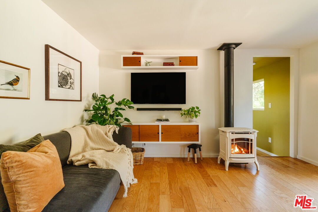 20906 Fontaine Road Topanga, CA 90290 - Photo 16 of 73 a living room with furniture and a flat screen tv