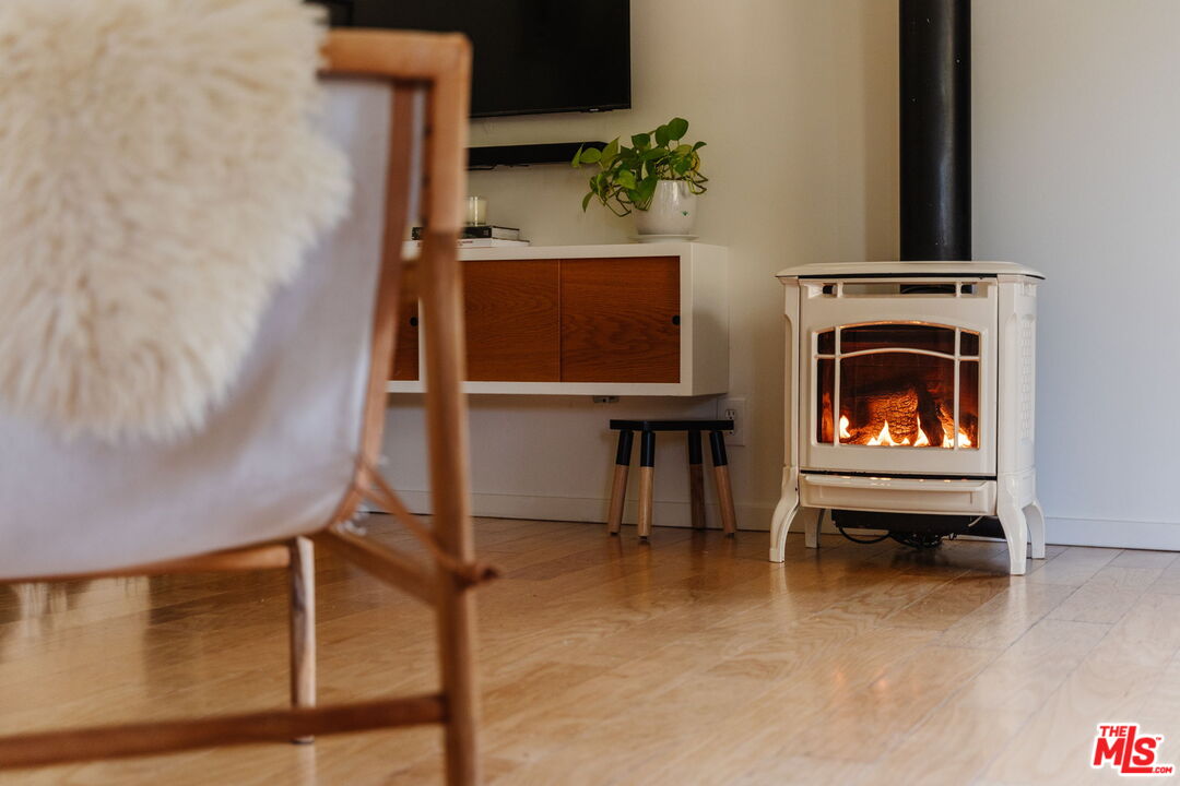 20906 Fontaine Road Topanga, CA 90290 - Photo 19 of 73 a living room with furniture a fireplace and a potted plant