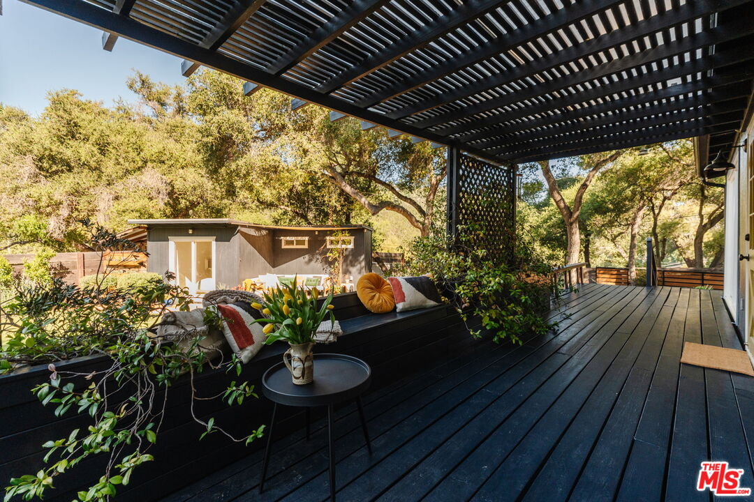 20906 Fontaine Road Topanga, CA 90290 - Photo 22 of 73 a view of a porch with furniture and wooden floor