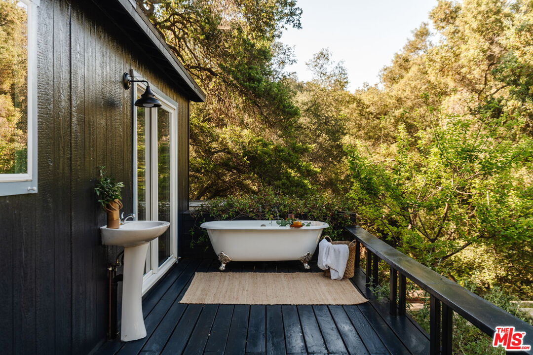 20906 Fontaine Road Topanga, CA 90290 - Photo 34 of 73 a view of a balcony with chair and wooden floor