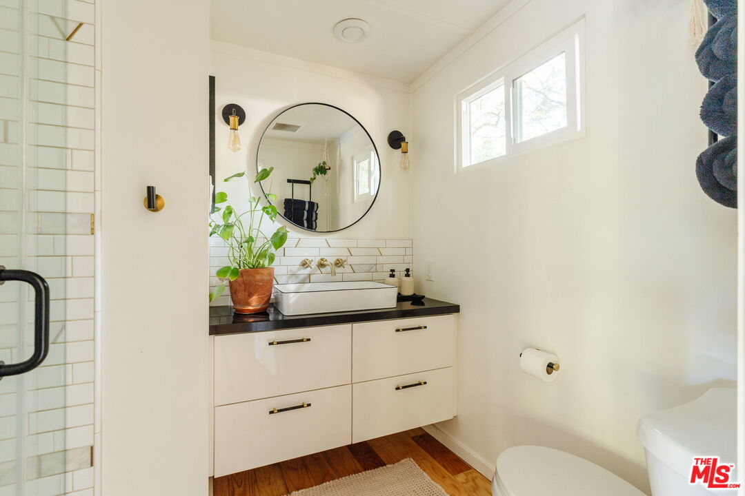 20906 Fontaine Road Topanga, CA 90290 - Photo 38 of 73 a bathroom with a sink a toilet and a mirror