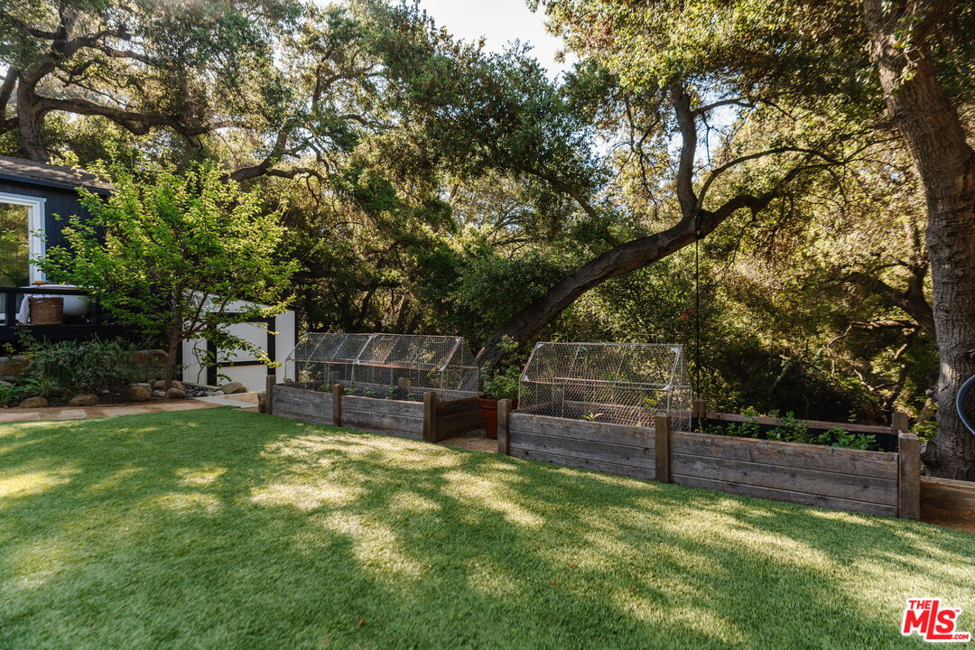 20906 Fontaine Road Topanga, CA 90290 - Photo 50 of 73 a view of a backyard with wooden fence and a bench