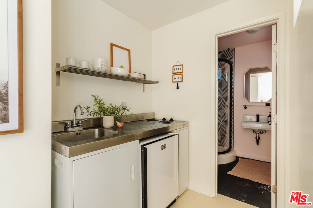 20906 Fontaine Road Topanga, CA 90290 - Photo 55 of 73 a kitchen with stainless steel appliances granite countertop a sink and cabinets
