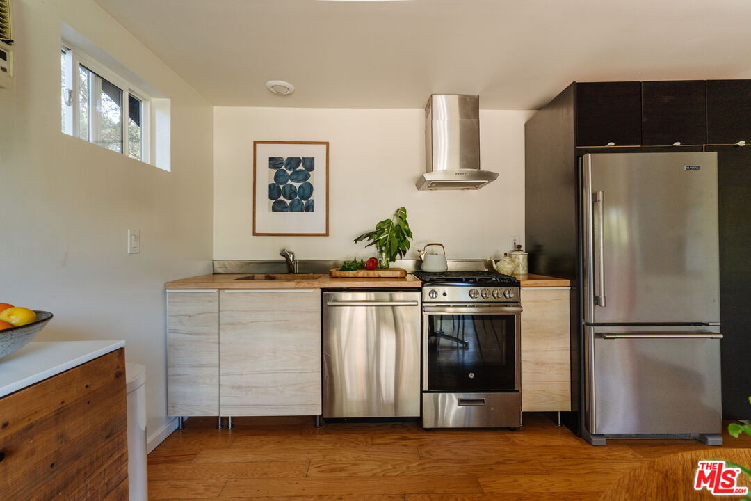 20906 Fontaine Road Topanga, CA 90290 - Photo 7 of 73 a kitchen with stainless steel appliances granite countertop a refrigerator and a stove top oven