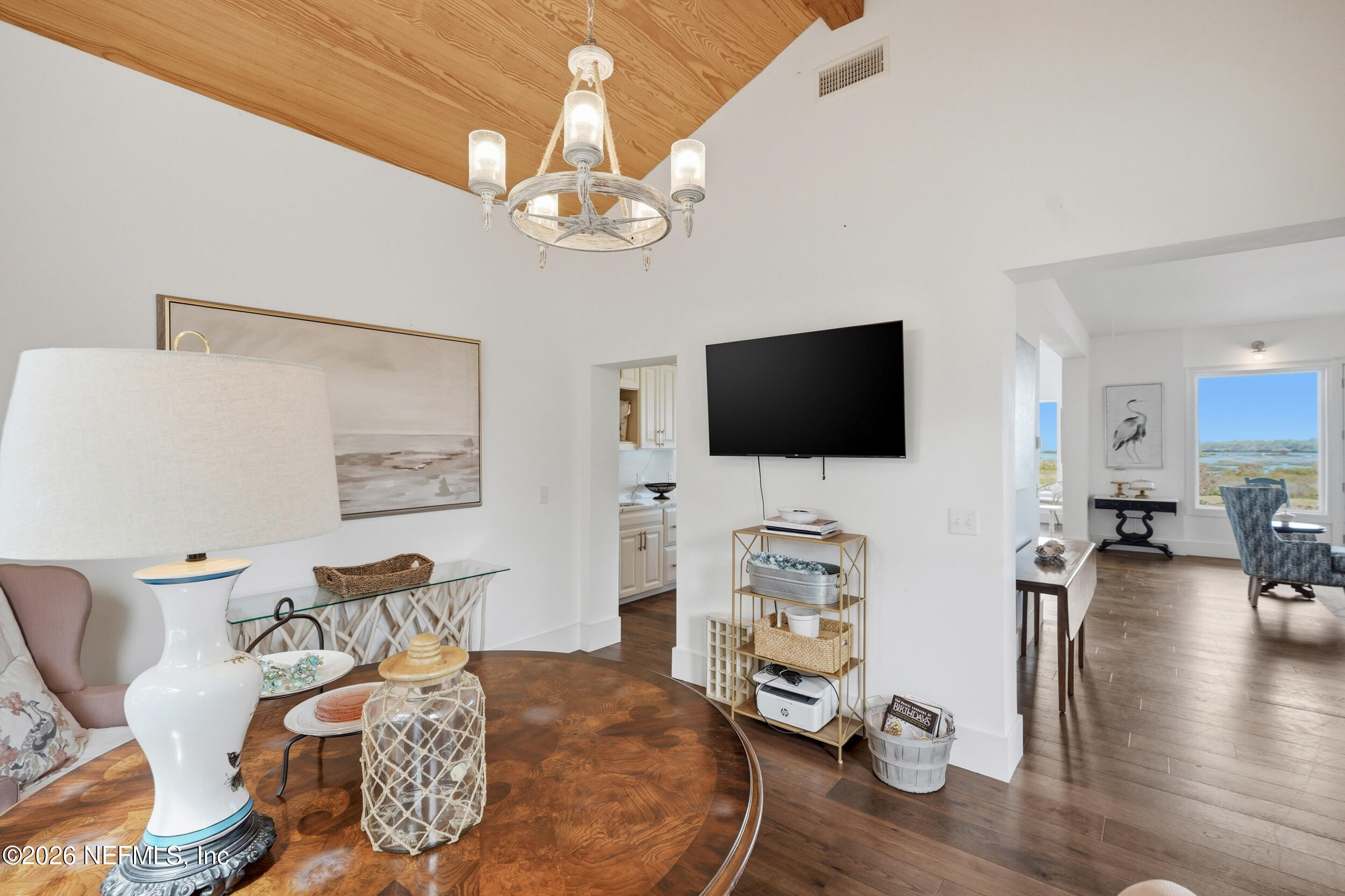 2406 Shore Drive St. Augustine, FL 32086 - Photo 32 of 108 a living room with furniture a flat screen tv and wooden floor