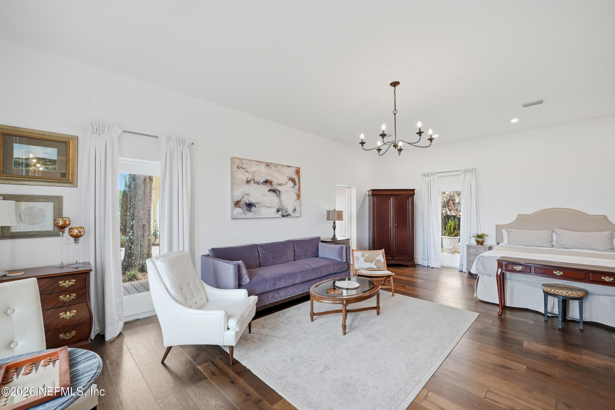 2406 Shore Drive St. Augustine, FL 32086 - Photo 33 of 108 a living room with furniture a fireplace and a chandelier