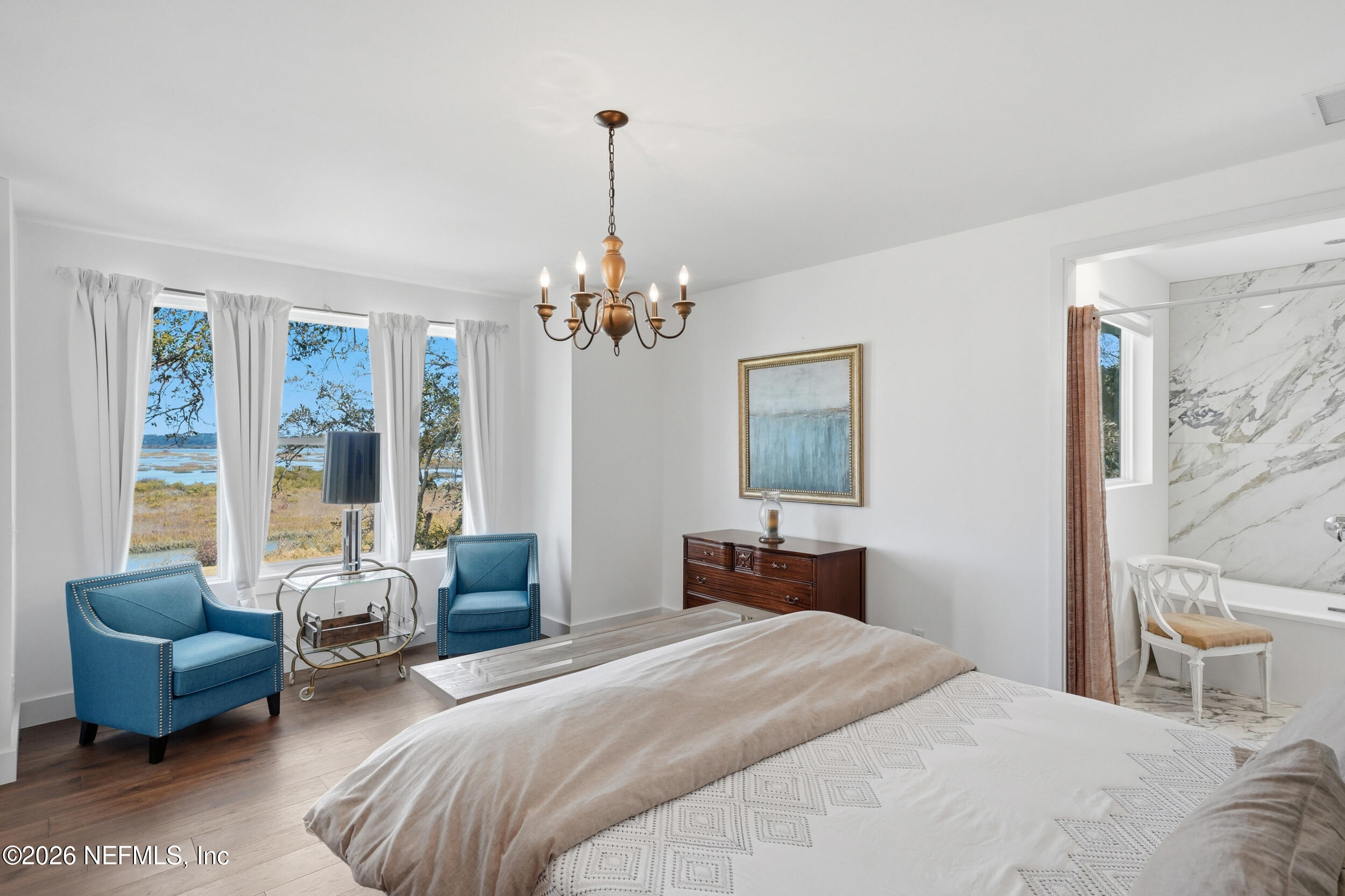 2406 Shore Drive St. Augustine, FL 32086 - Photo 53 of 108 a bedroom with a large bed and a chandelier