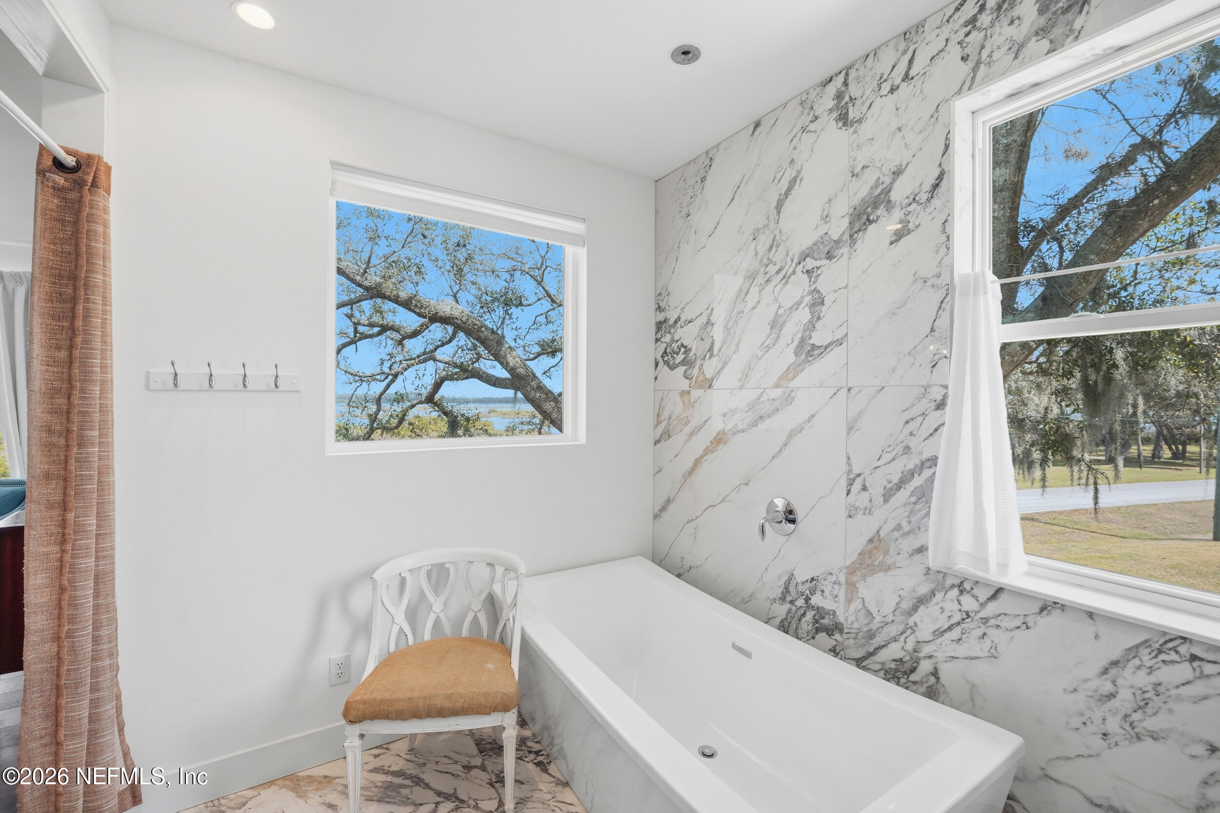 2406 Shore Drive St. Augustine, FL 32086 - Photo 56 of 108 a bathroom with a bathtub and a window