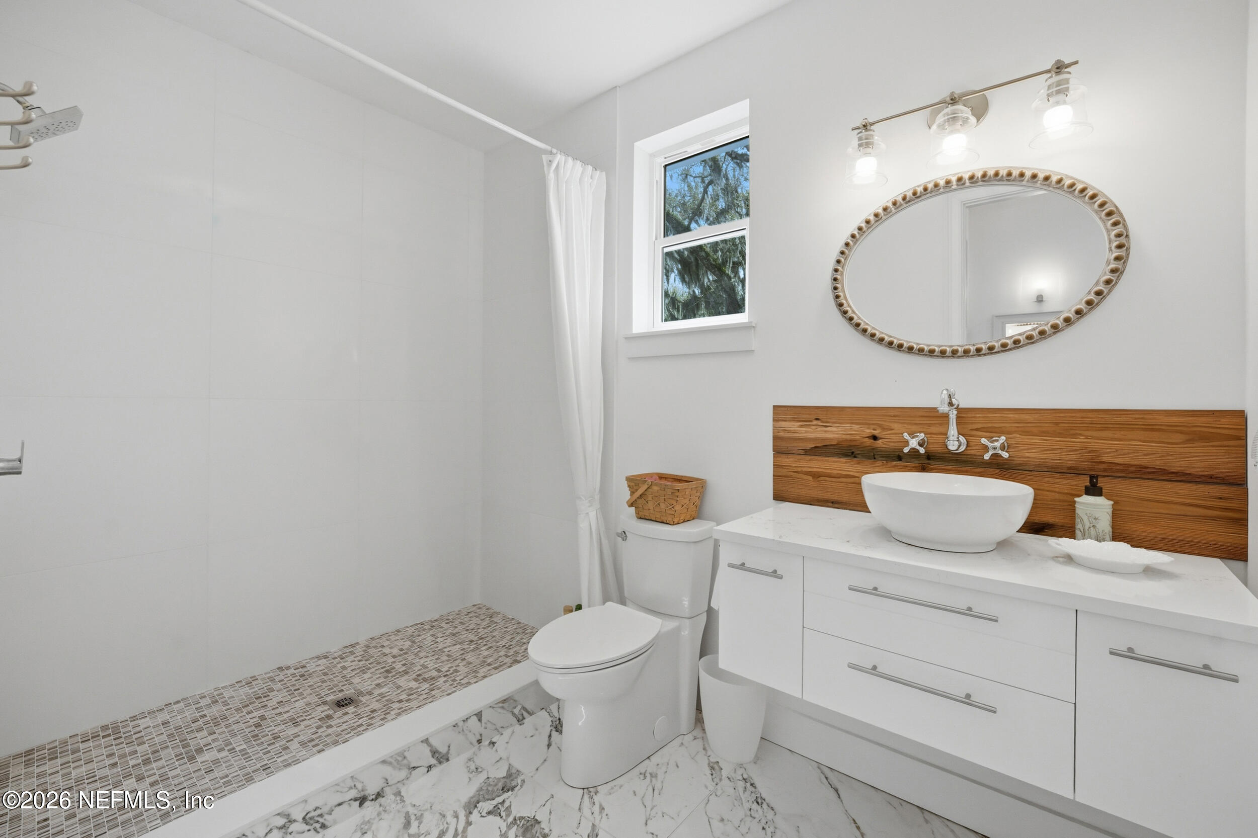 2406 Shore Drive St. Augustine, FL 32086 - Photo 64 of 108 a bathroom with a toilet a sink and mirror