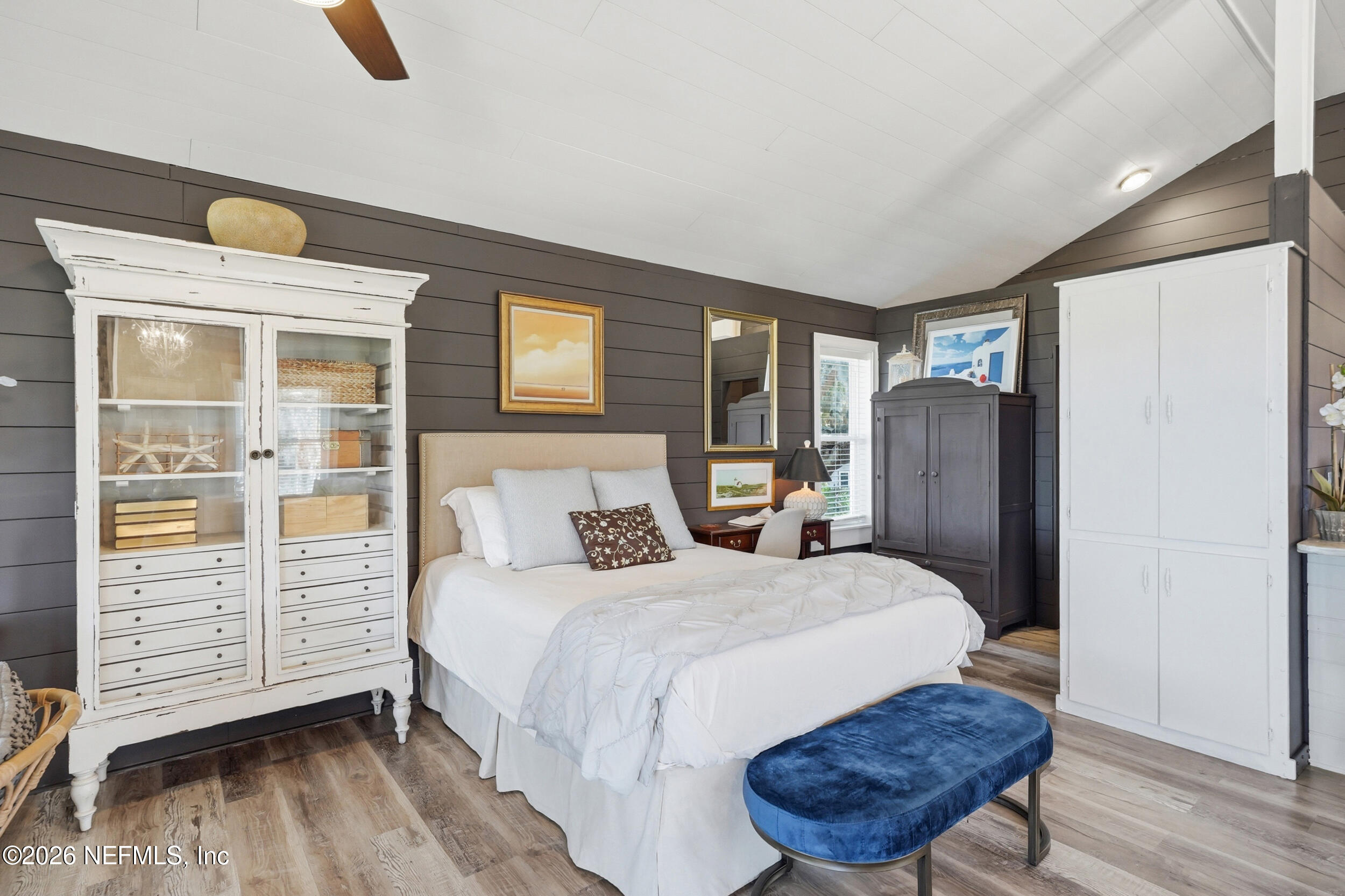 2406 Shore Drive St. Augustine, FL 32086 - Photo 78 of 108 a bedroom with a bed a dresser and wooden floor