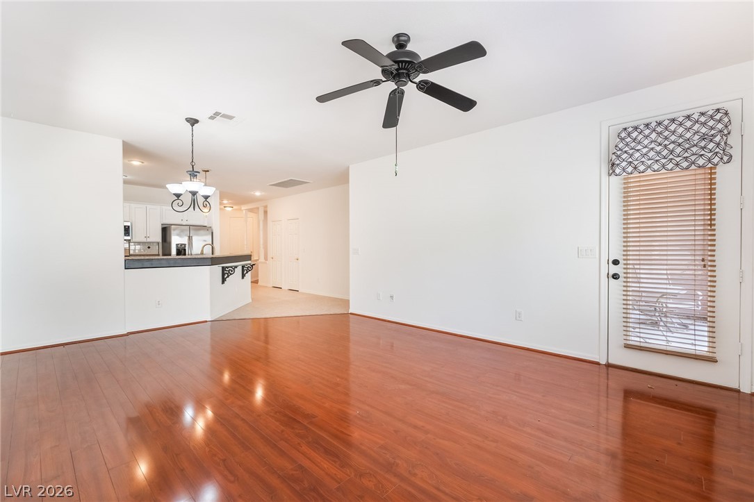 5389 Progresso Street Las Vegas, NV 89135 - Photo 15 of 41 Hardwood floors and an open concept create a seamless flow between the living area and kitchen.
