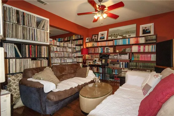 a living room with furniture a bookshelf and a book shelf